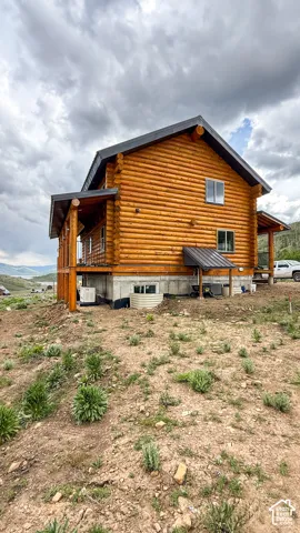 Rear view of property with log exterior