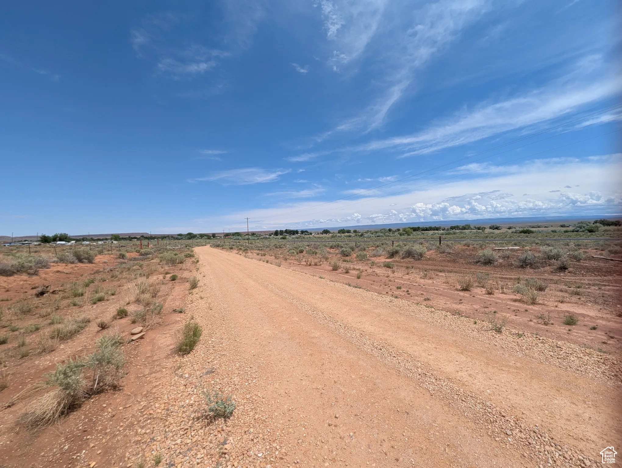 View of dirt / gravel road featuring a view of rural / pastoral area