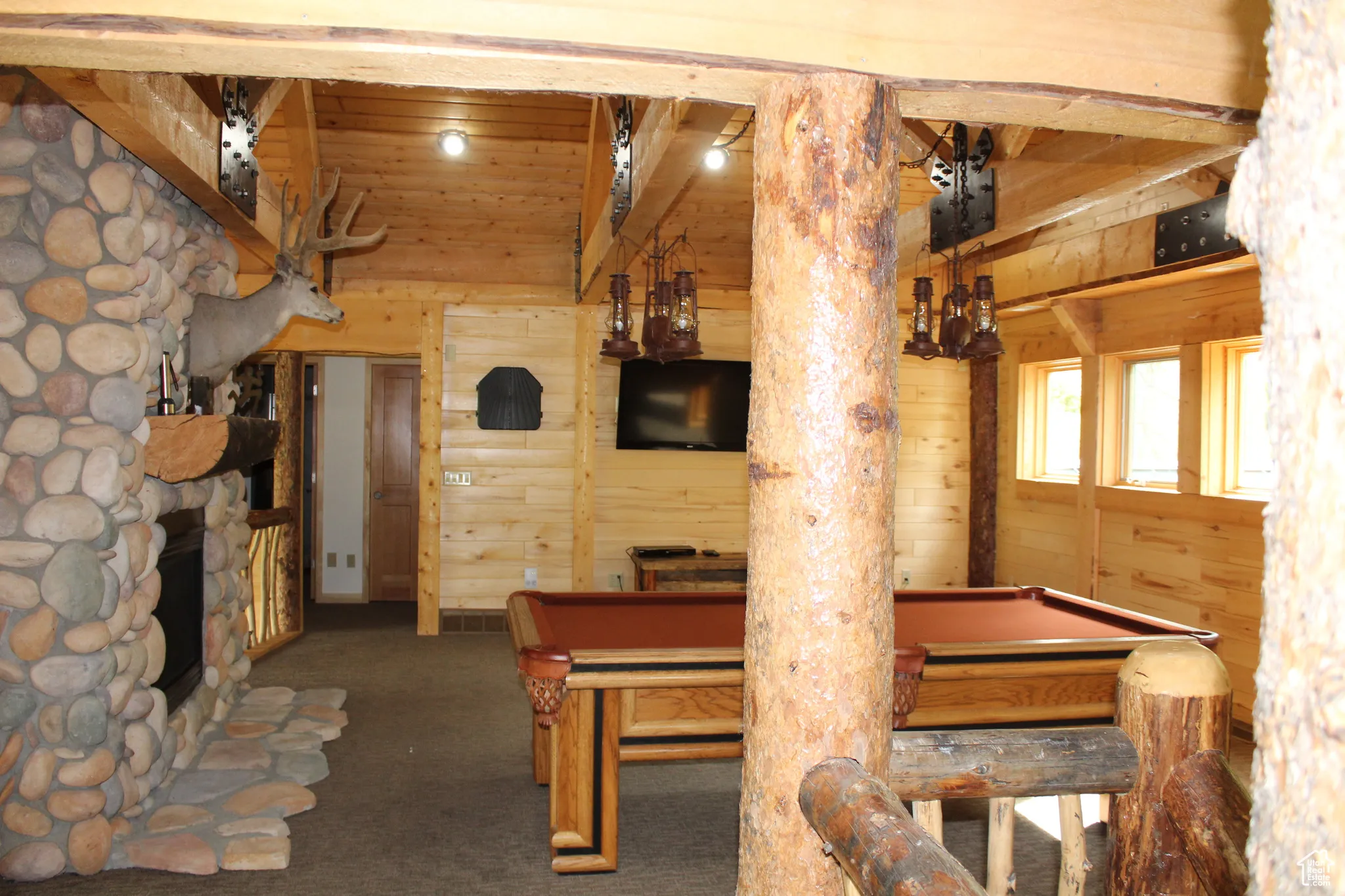 Dining room featuring billiards, wood walls, and carpet floors