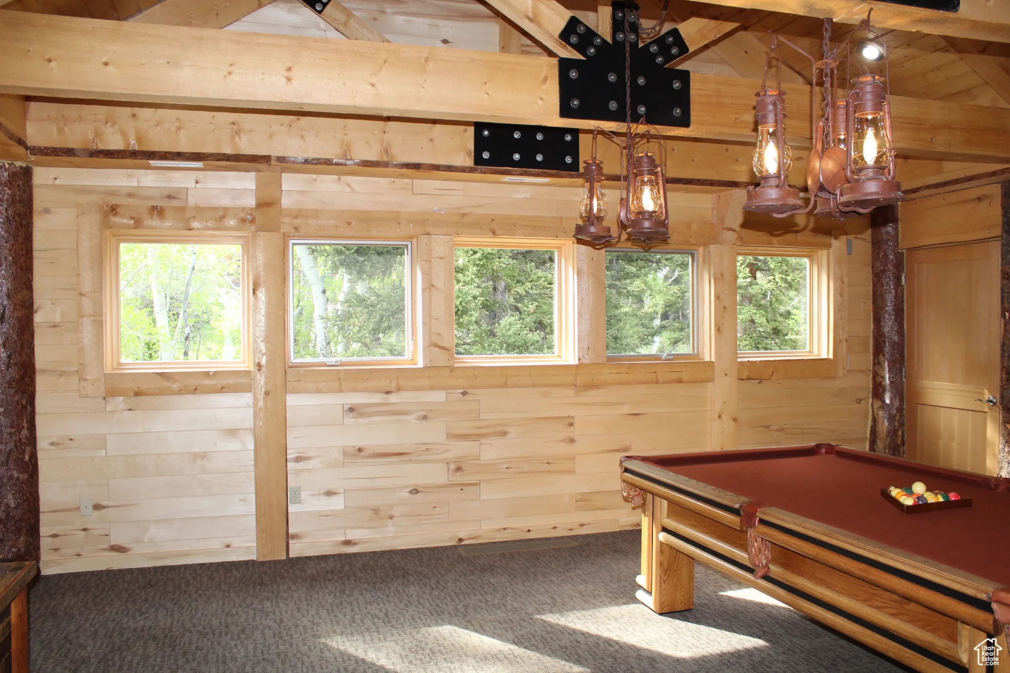 Rec room featuring wooden walls, carpet floors, billiards table, a chandelier, and beam ceiling