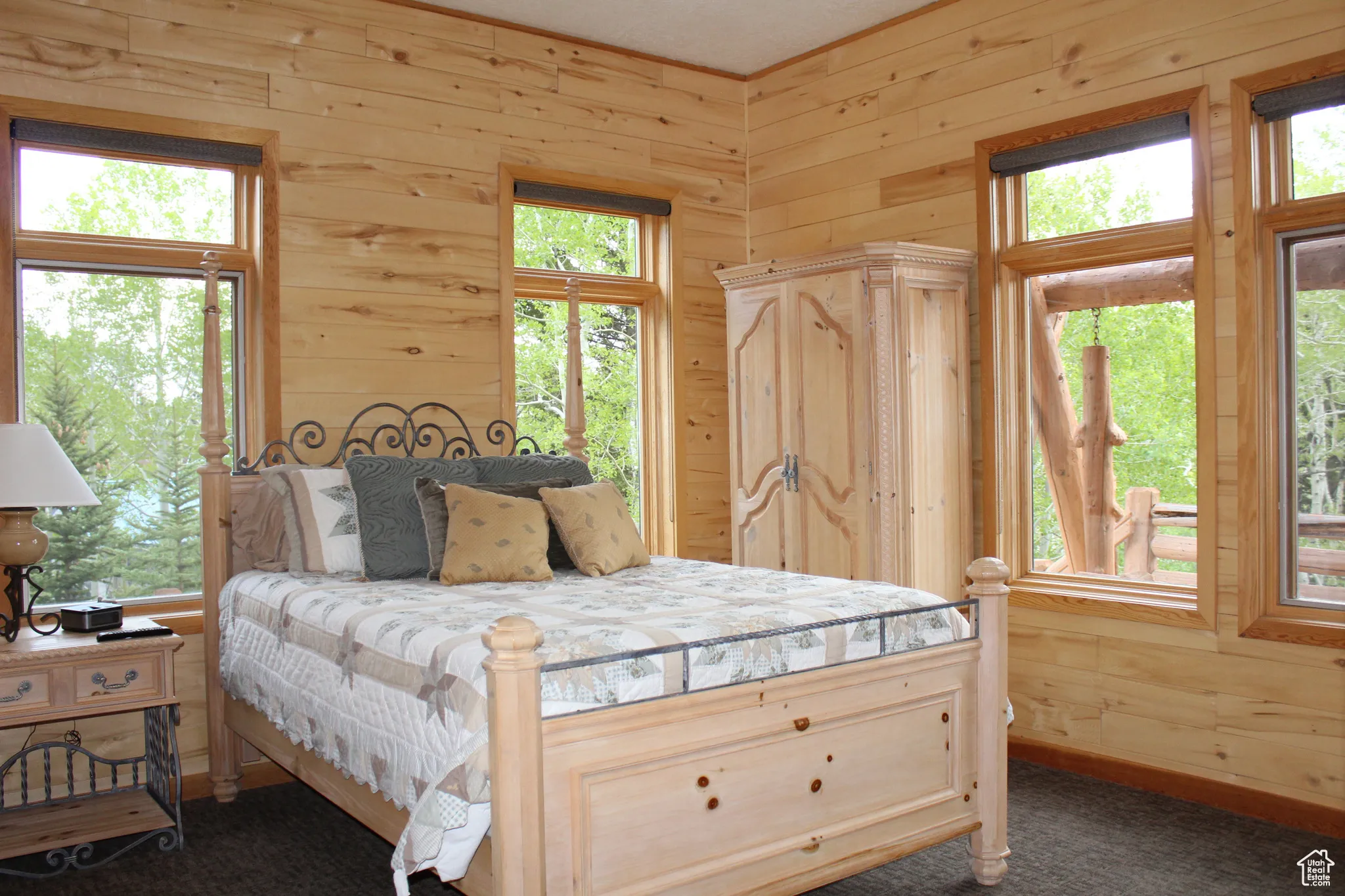 Bedroom featuring wood walls and dark colored carpet
