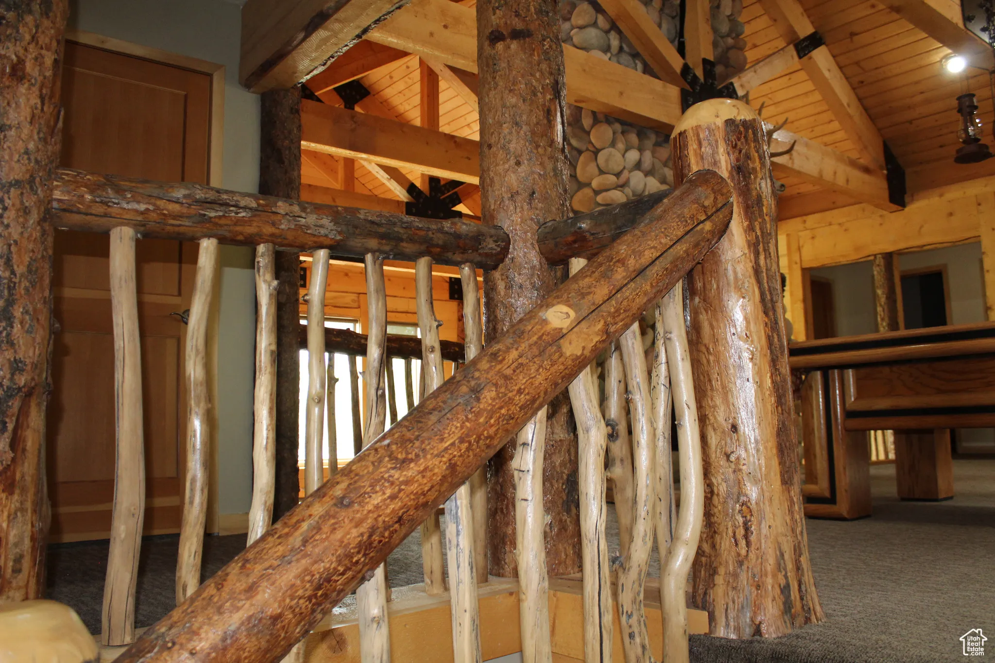 Staircase featuring wooden ceiling and carpet