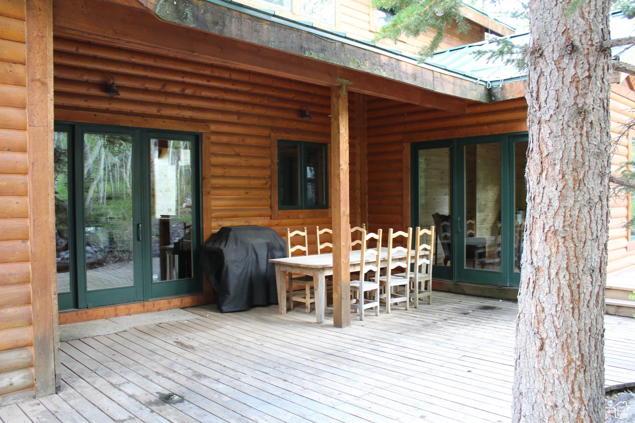 Wooden deck featuring area for grilling and outdoor dining space