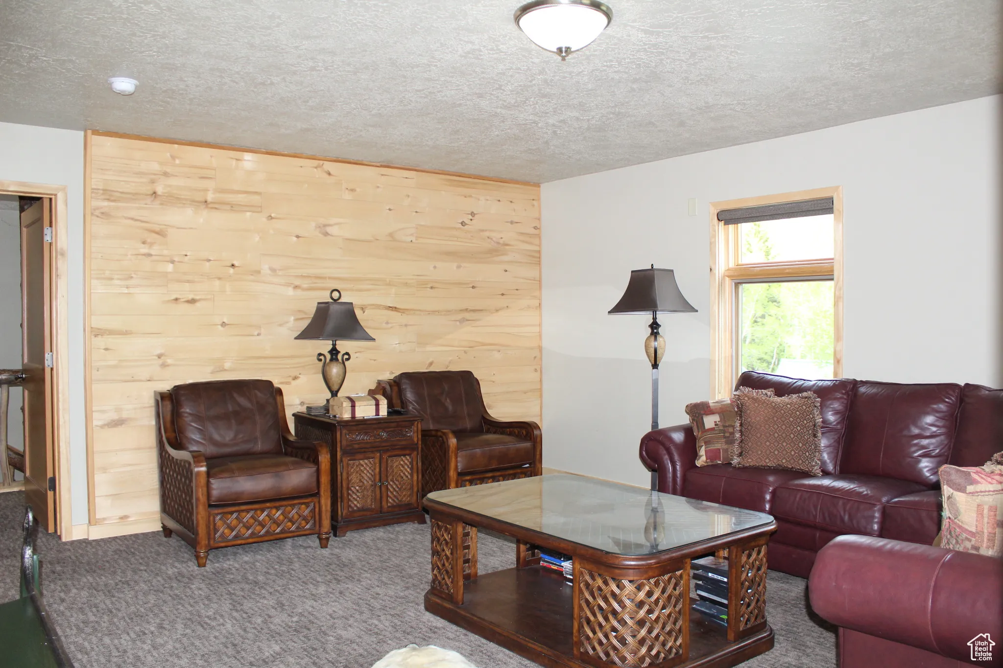 Living room with carpet floors and a textured ceiling