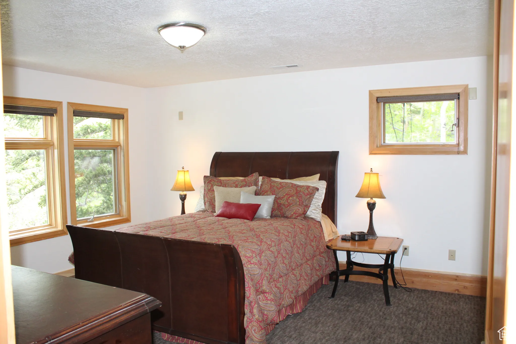 Bedroom featuring a textured ceiling and baseboards