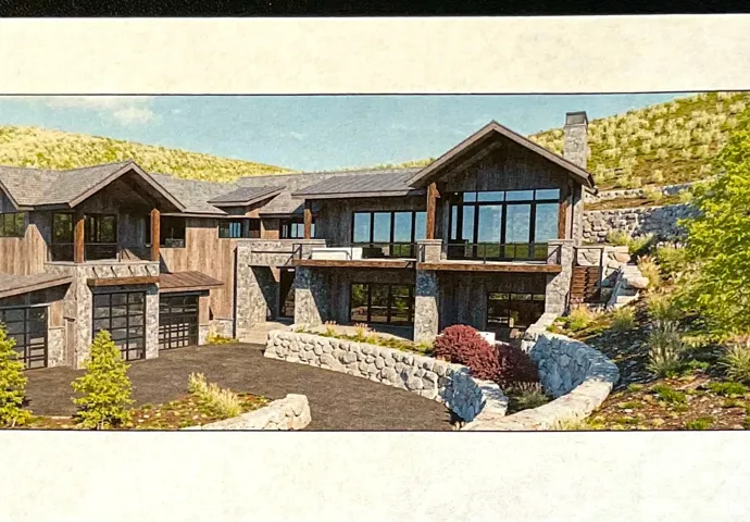 View of front of property with stone siding, an attached garage, a chimney, driveway, and a balcony