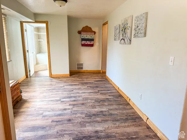 Hall featuring wood finished floors and baseboards
