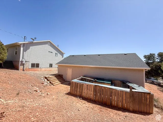 Rear view of property featuring stairs