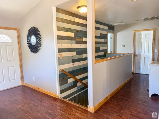 Entrance foyer with wood finished floors and baseboards