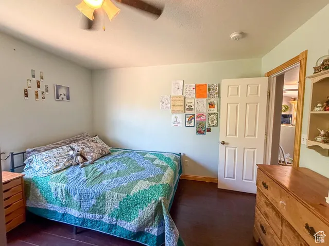Bedroom featuring dark wood finished floors and ceiling fan