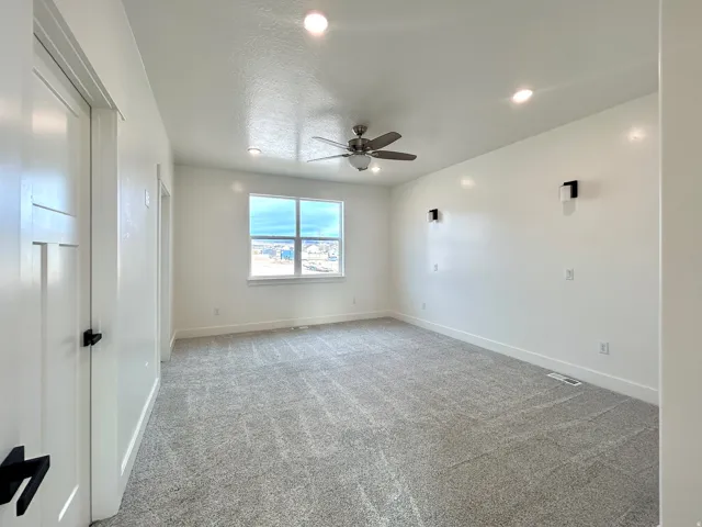 Unfurnished room with light colored carpet, recessed lighting, a ceiling fan, and a textured ceiling