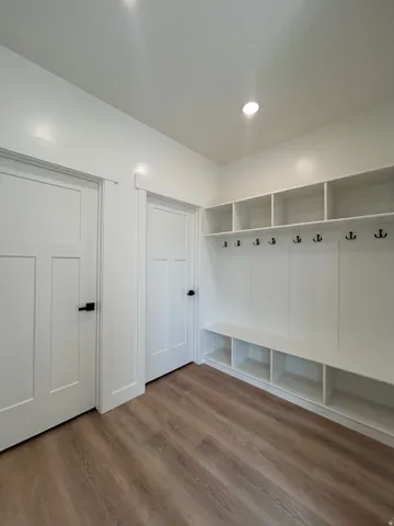 Mudroom featuring light wood finished floors and recessed lighting