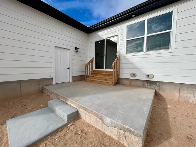 Doorway to property with a patio area