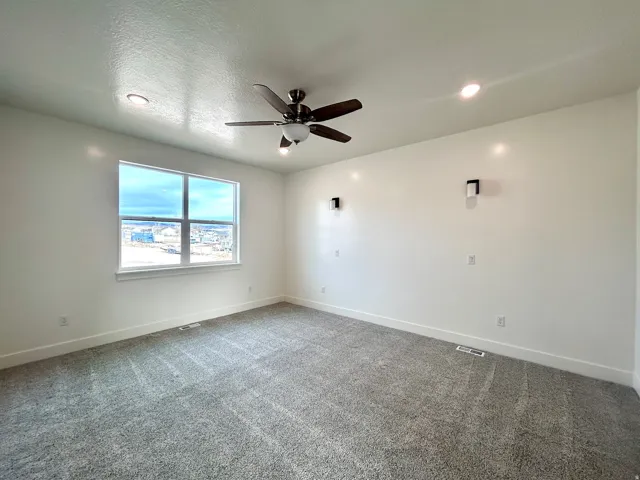 Spare room with a ceiling fan, carpet flooring, a textured ceiling, and recessed lighting