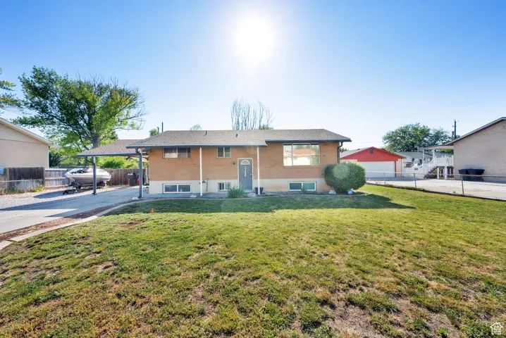 Raised ranch featuring driveway and a carport