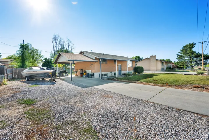 View of front of home with gravel driveway