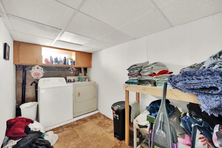 Laundry area featuring independent washer and dryer and cabinet space