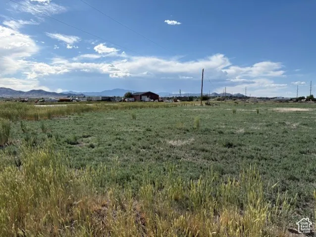 View of undeveloped land featuring rural landscape and mountains