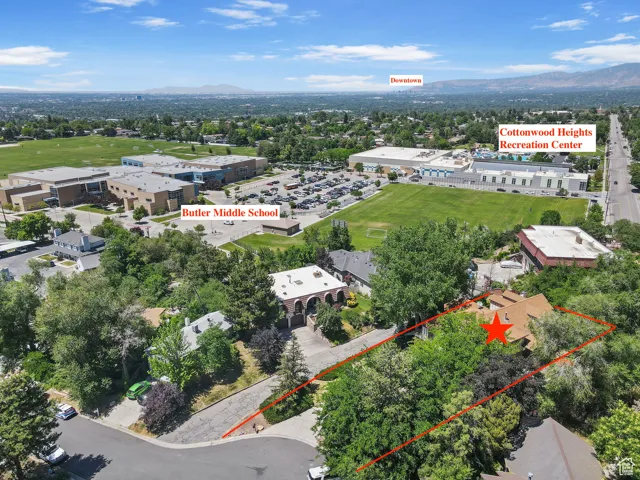 Aerial overview of property's location with property boundaries highlighted and a mountainous background