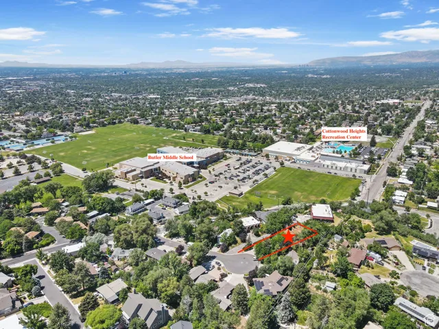 Aerial view of property and surrounding area with a mountainous background and property boundaries highlighted