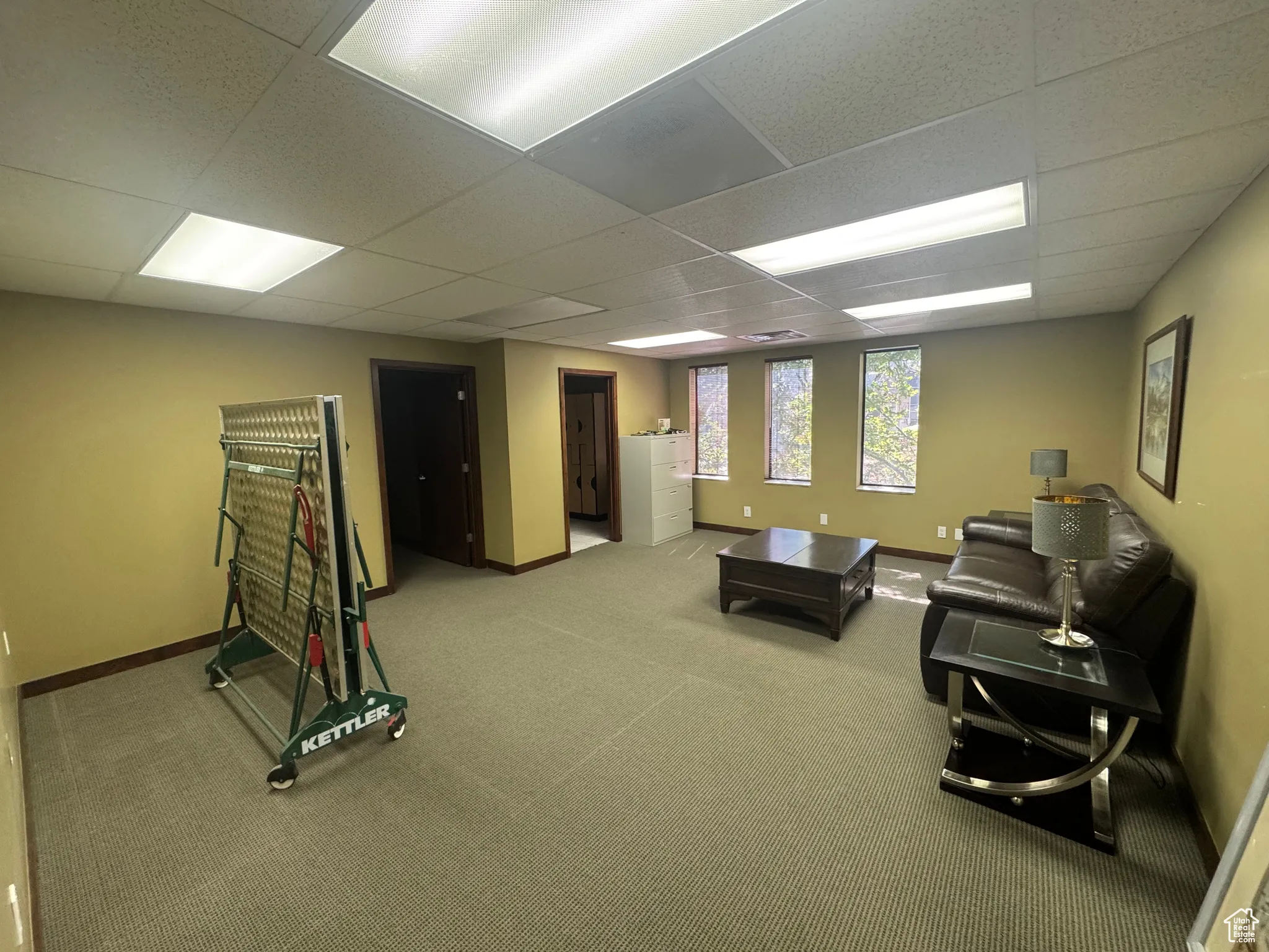 Rec room featuring a drop ceiling and carpet floors
