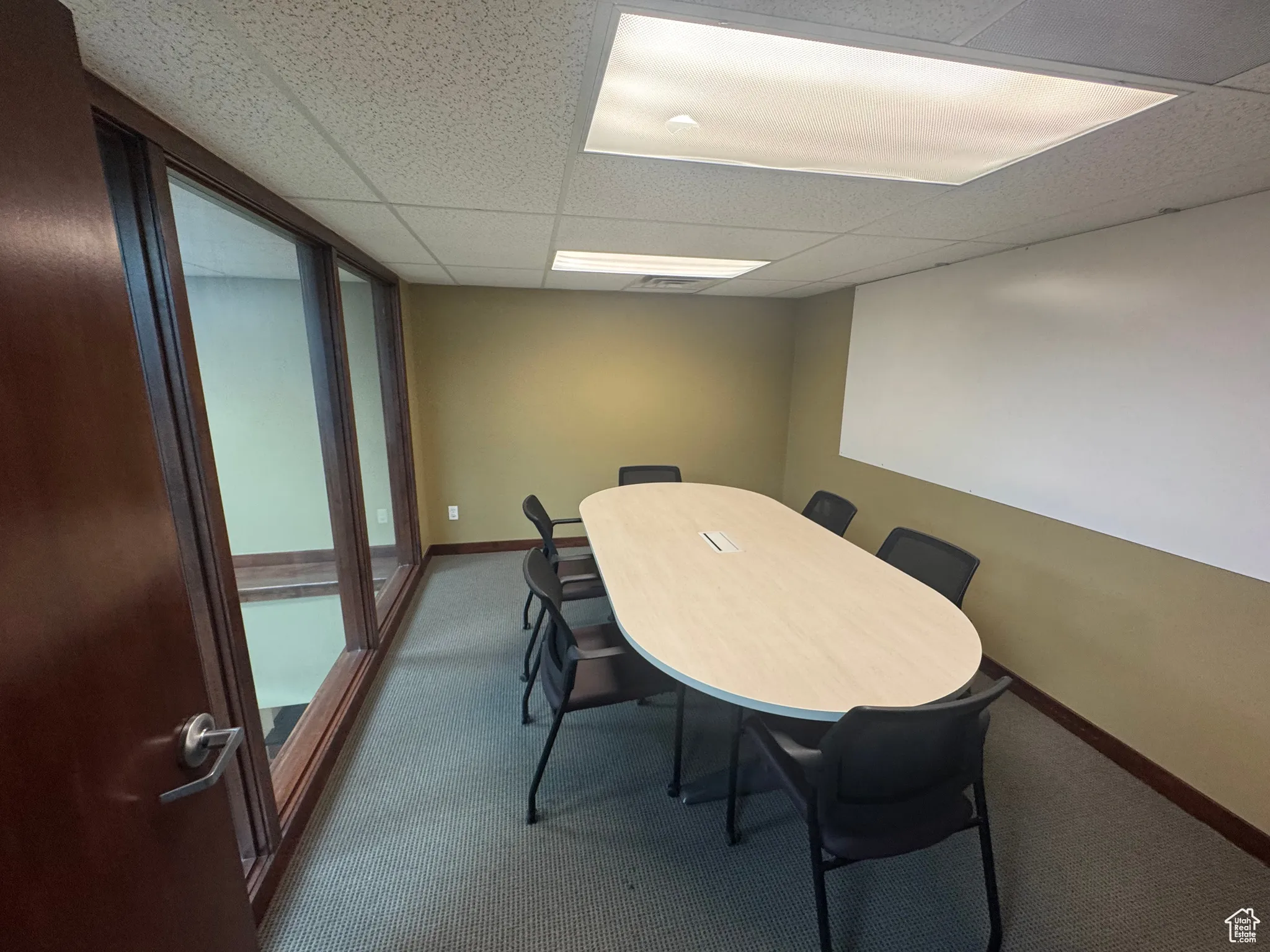 Dining space with carpet and a drop ceiling