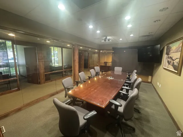 Office with carpet floors, healthy amount of natural light, and recessed lighting