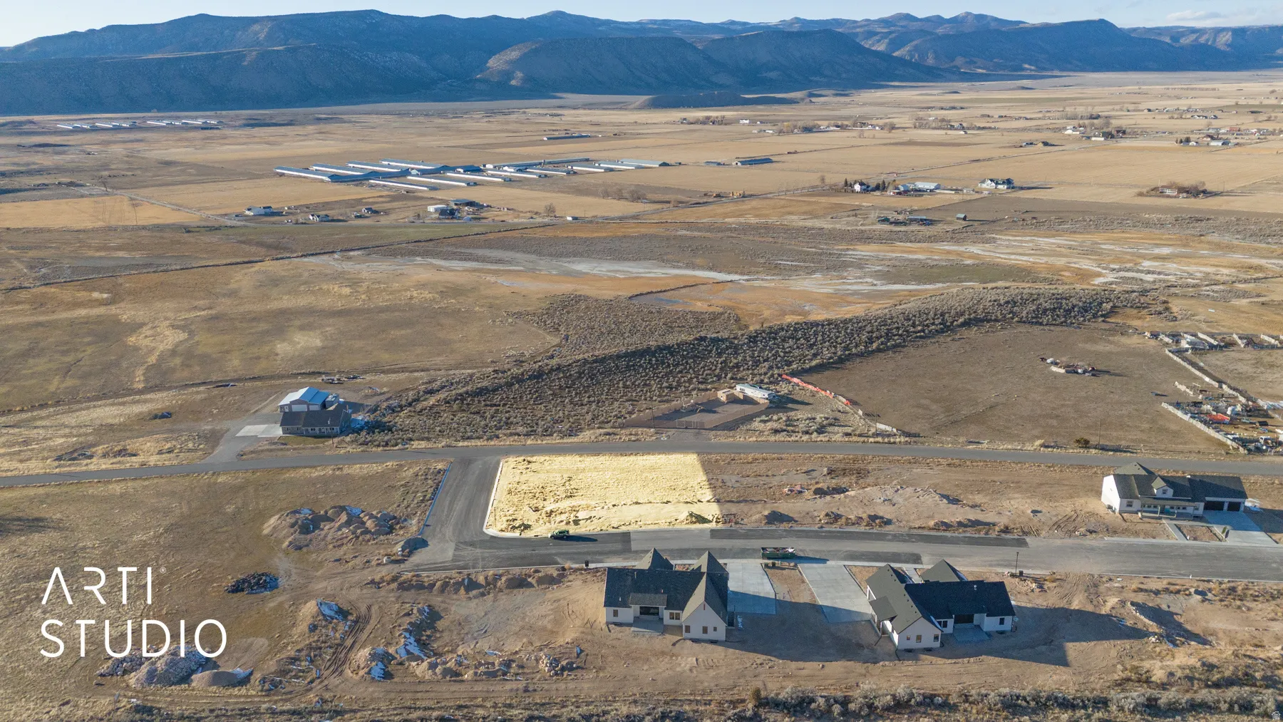 Expansive land parcel featuring a prepared building site and direct road frontage