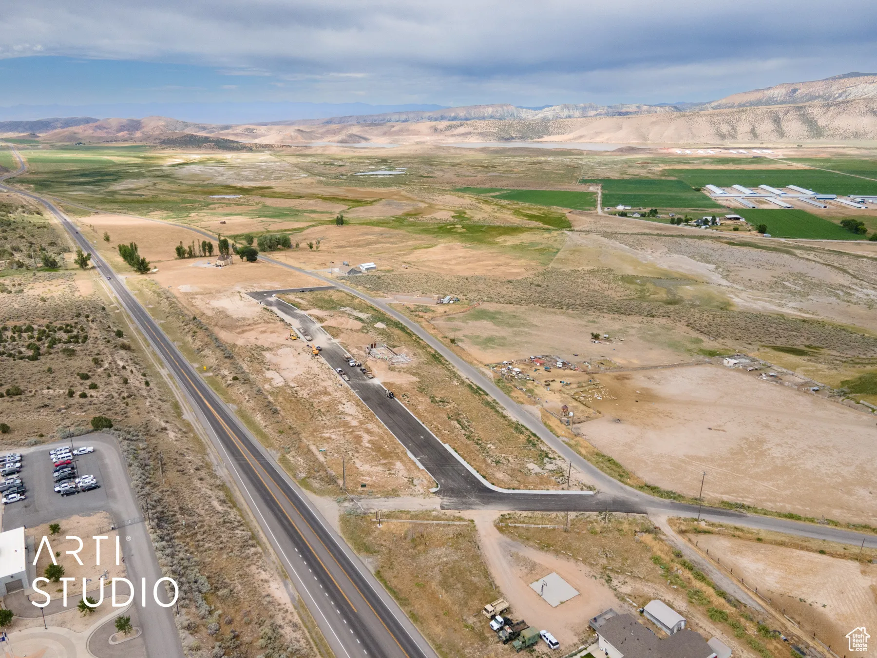Aerial view of property and surrounding area with a mountain backdrop and rural landscape