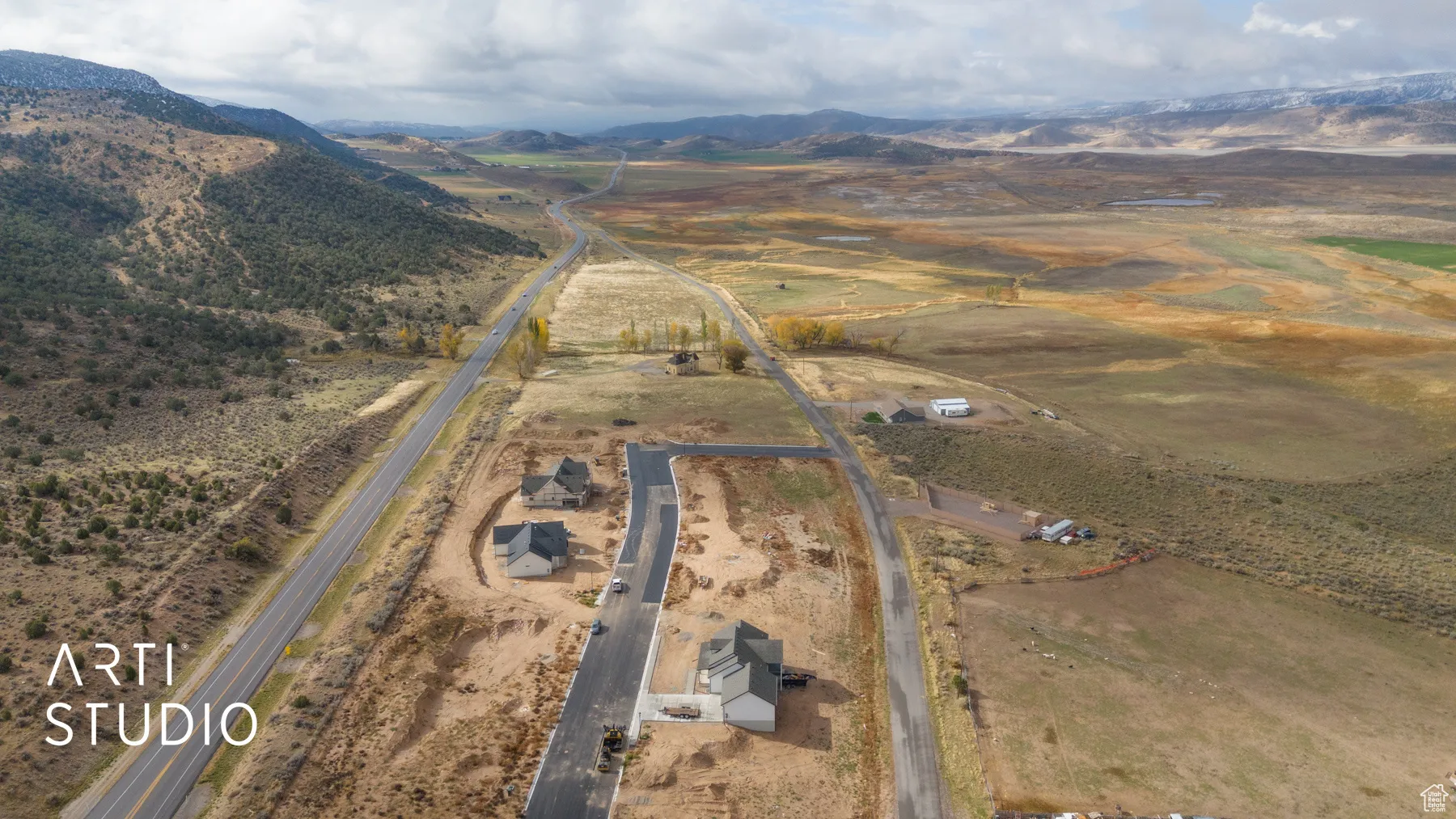 Aerial view of property's location featuring a mountain backdrop and rural landscape