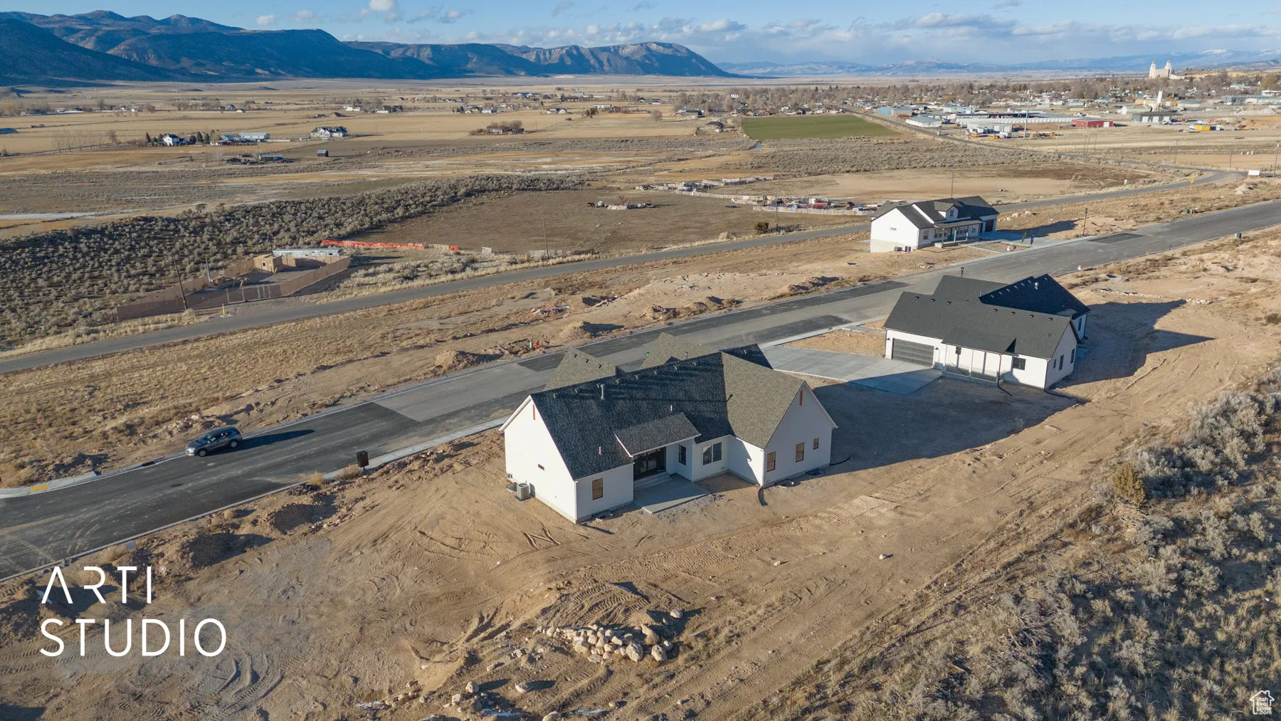 Aerial view of sparsely populated area with a mountain backdrop