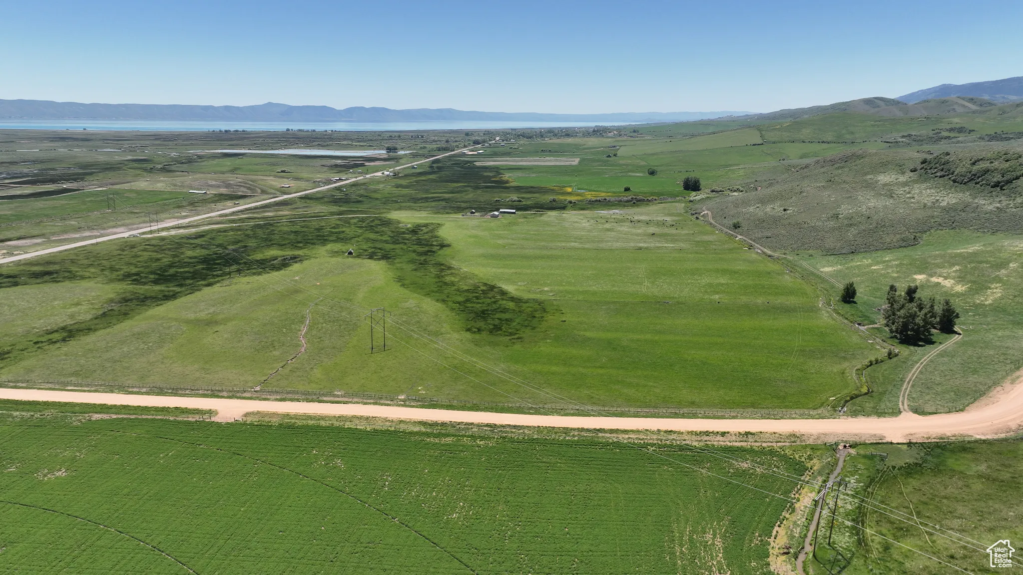 Aerial overview of property's location with rural landscape and mountains