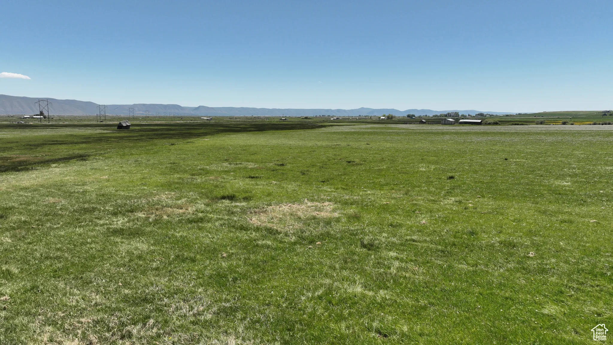 View of green lawn featuring a view of rural / pastoral area and a mountain view