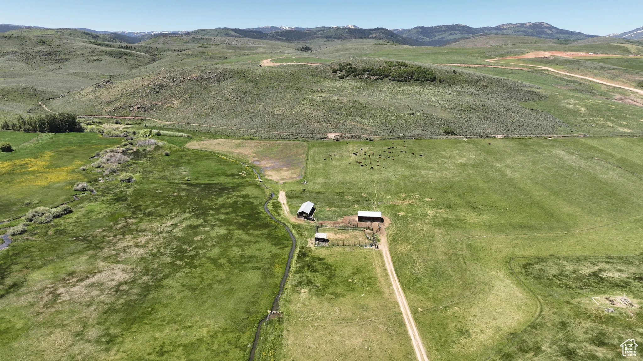 Aerial overview of property's location with a mountain backdrop and rural landscape