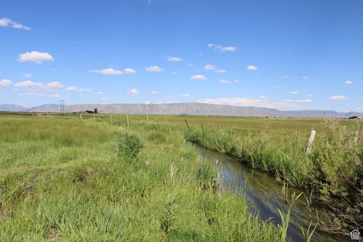 View of mountain backdrop featuring rural landscape