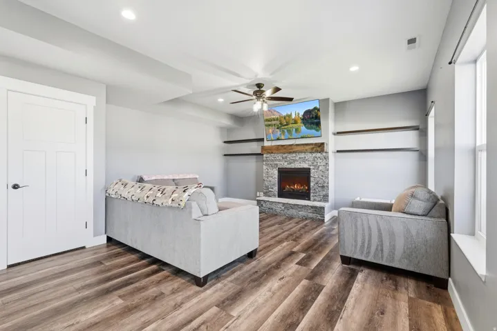 Wood-finish flooring, recessed lighting, and a ceiling fan