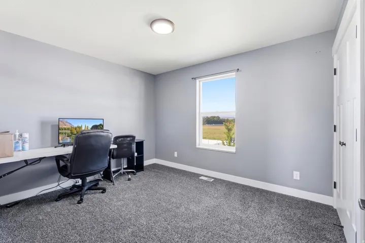 Neutral-toned walls complement the gray carpeting