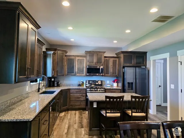 Everyone loves an island and black stainless steel appliances.