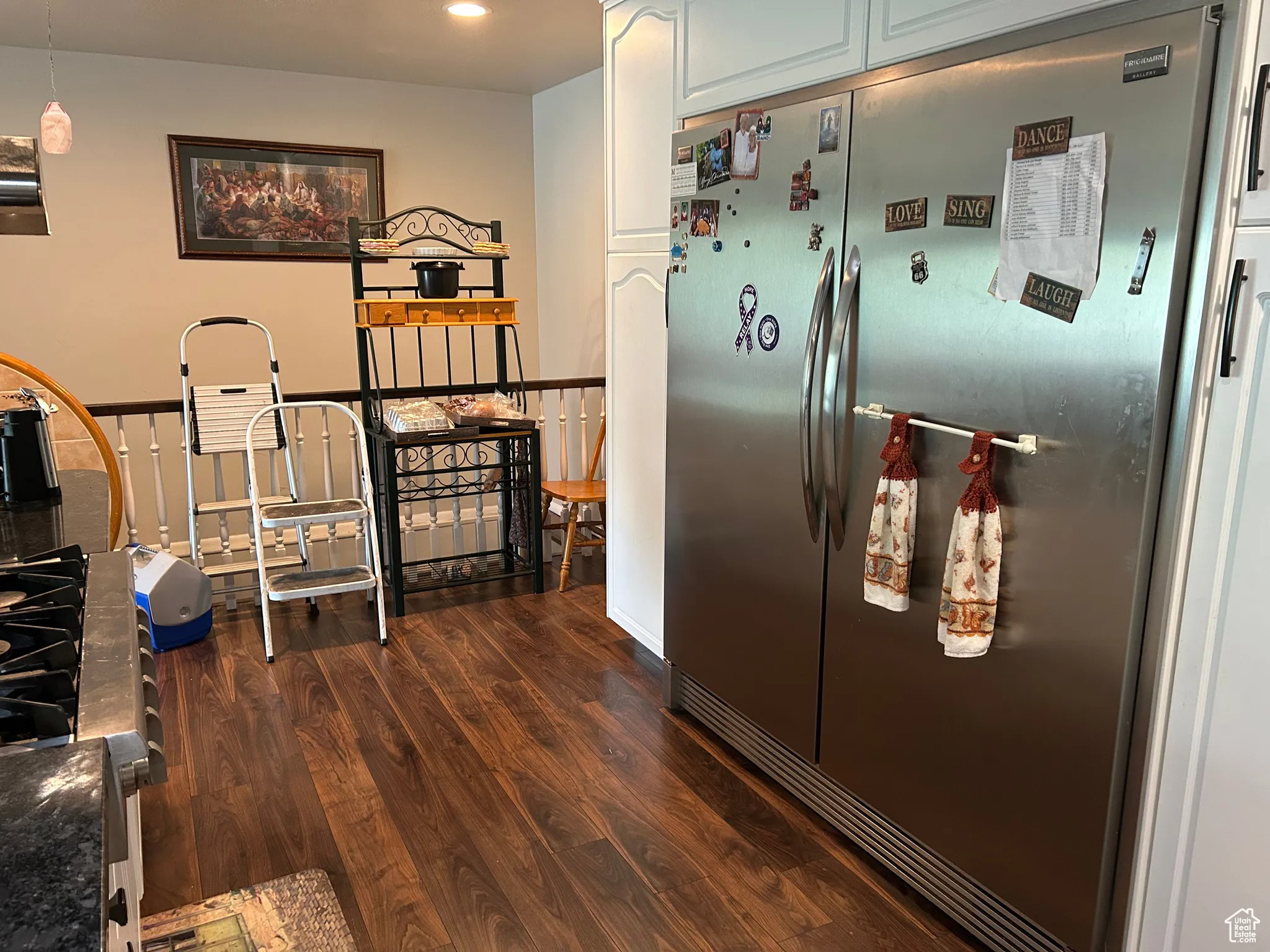 Kitchen featuring freestanding refrigerator, dark wood finished floors, recessed lighting, dark countertops, and white cabinetry