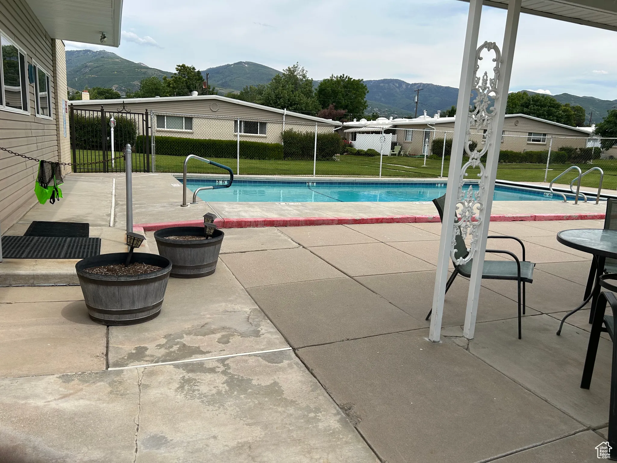 View of pool with a mountain view and a patio area