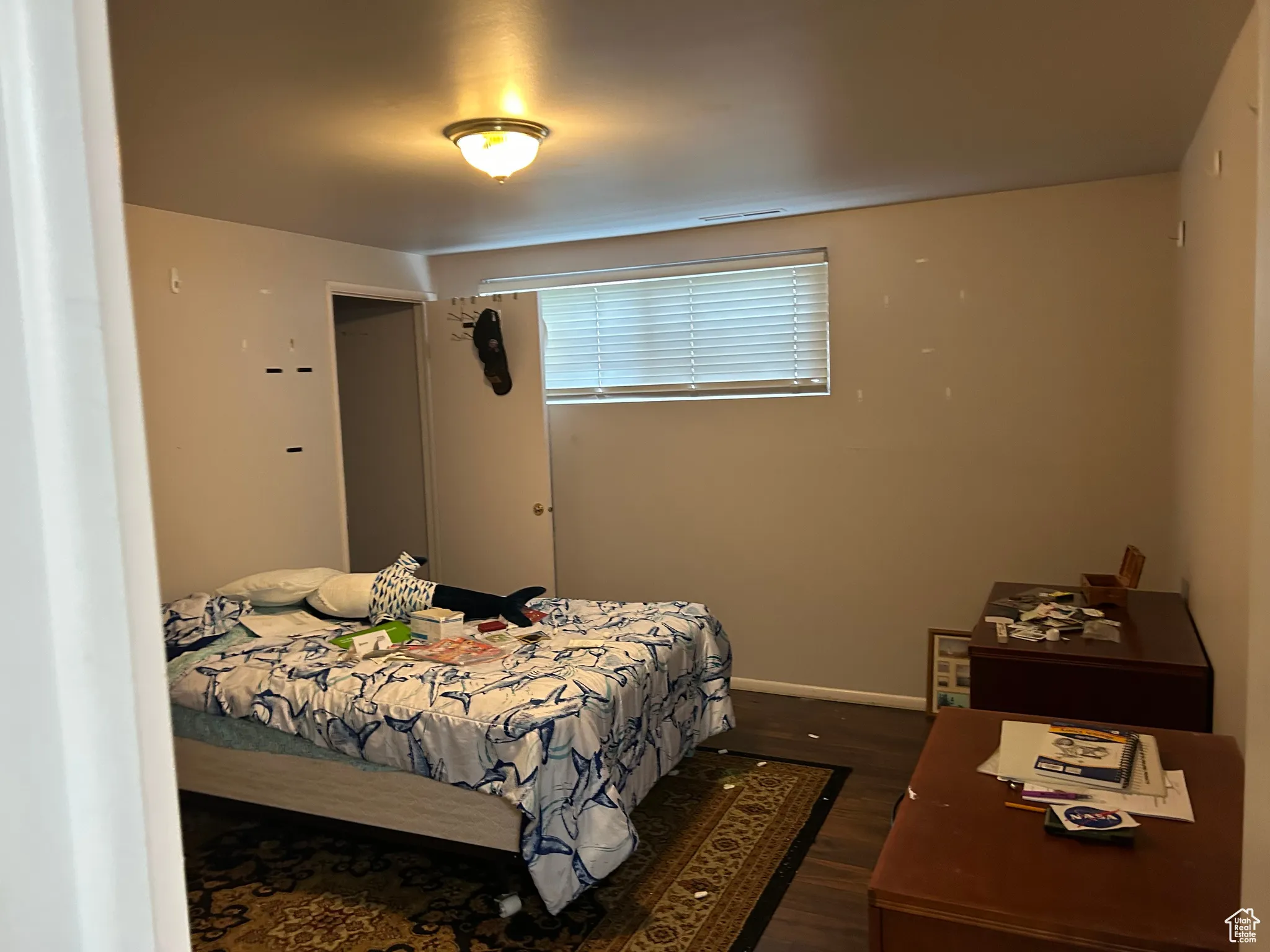 Bedroom featuring dark wood finished floors and baseboards