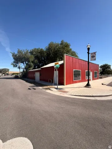 Red corrugated metal siding with white trim