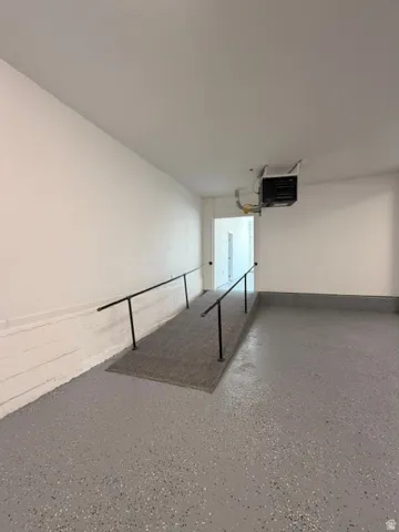 Epoxy-coated flooring, built-in ramp with handrails, and a ceiling-mounted heating unit
