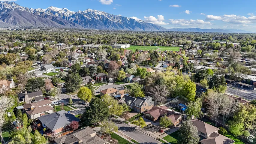 Aerial view of property and surrounding area with nearby suburban area