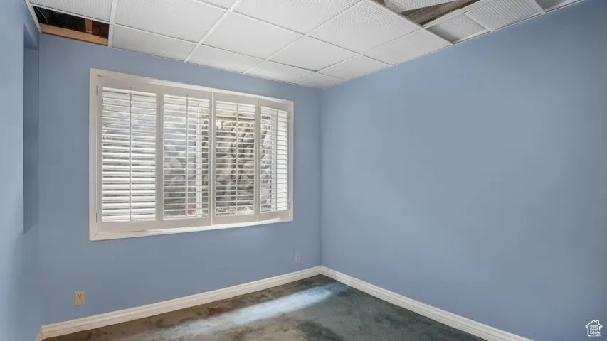 Carpeted spare room with baseboards