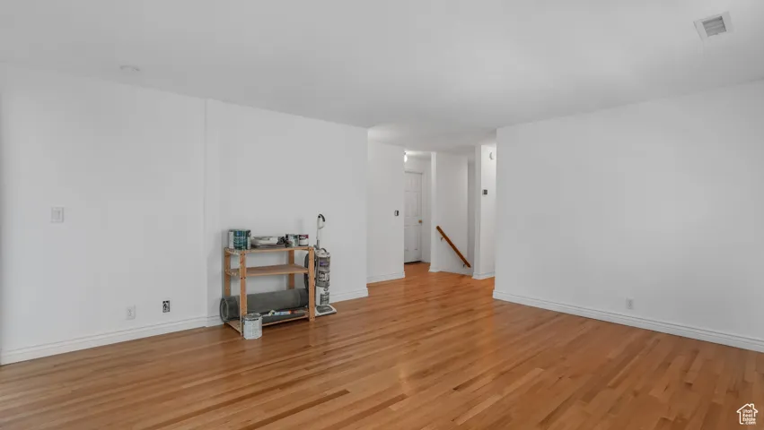 Spare room featuring light wood-type flooring and a smoke detector