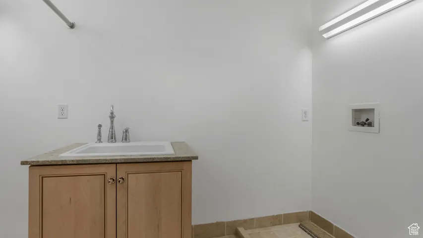 Laundry area featuring washer hookup and tile patterned floors