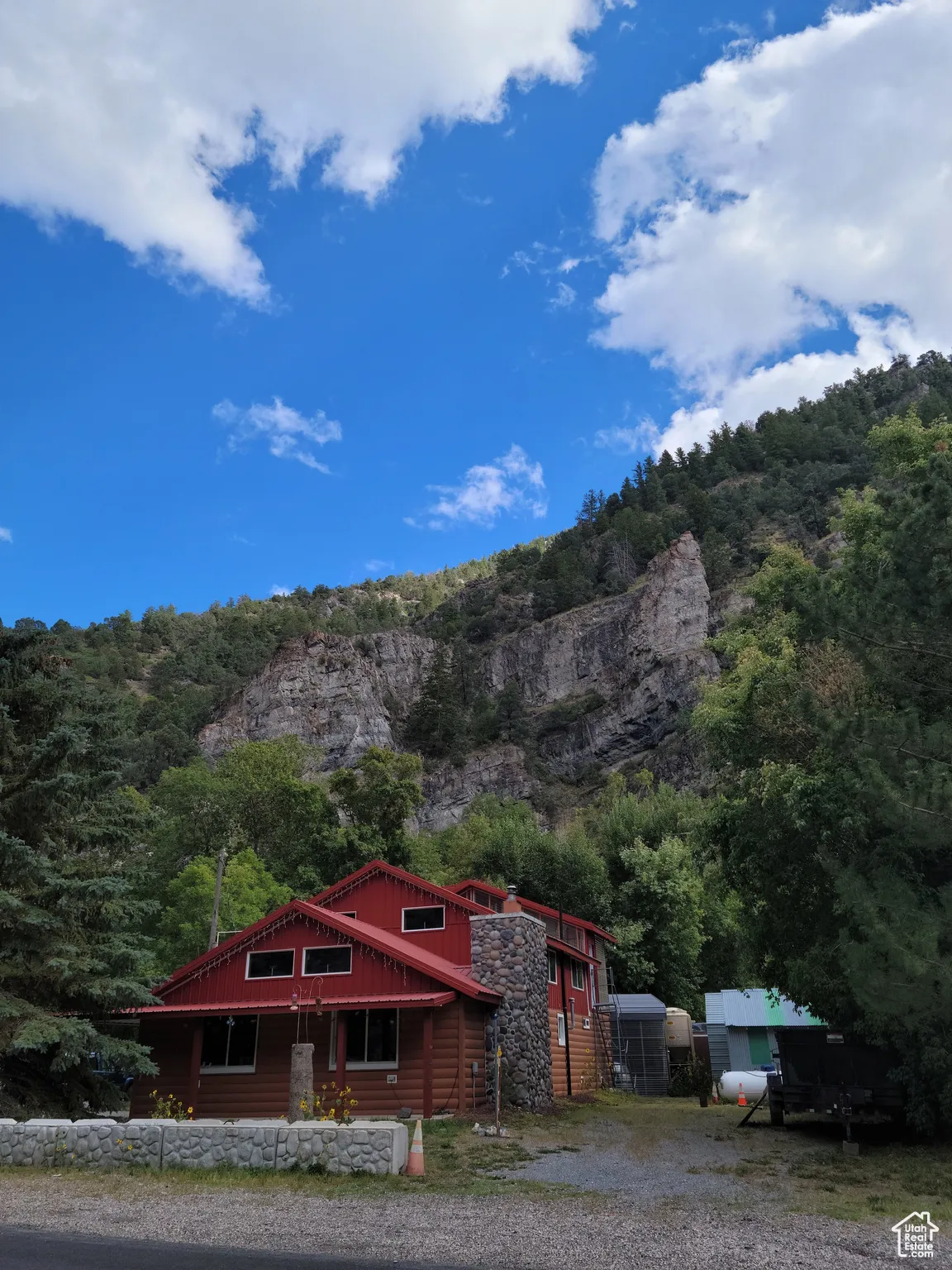 View of Home with mountain backdrop with a heavily wooded area