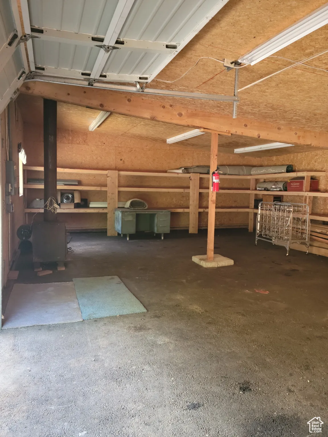 View of garage/workshop with wood burning stove