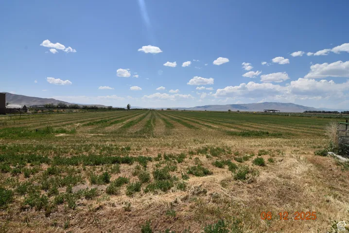View of mountain backdrop featuring rural landscape